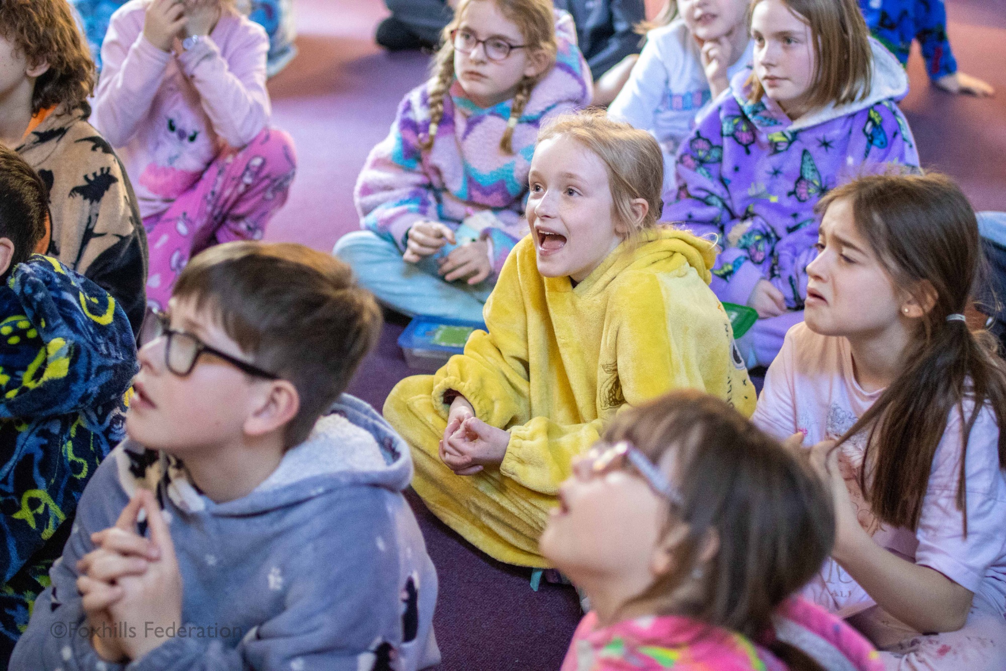 Children listen to a story being read to them