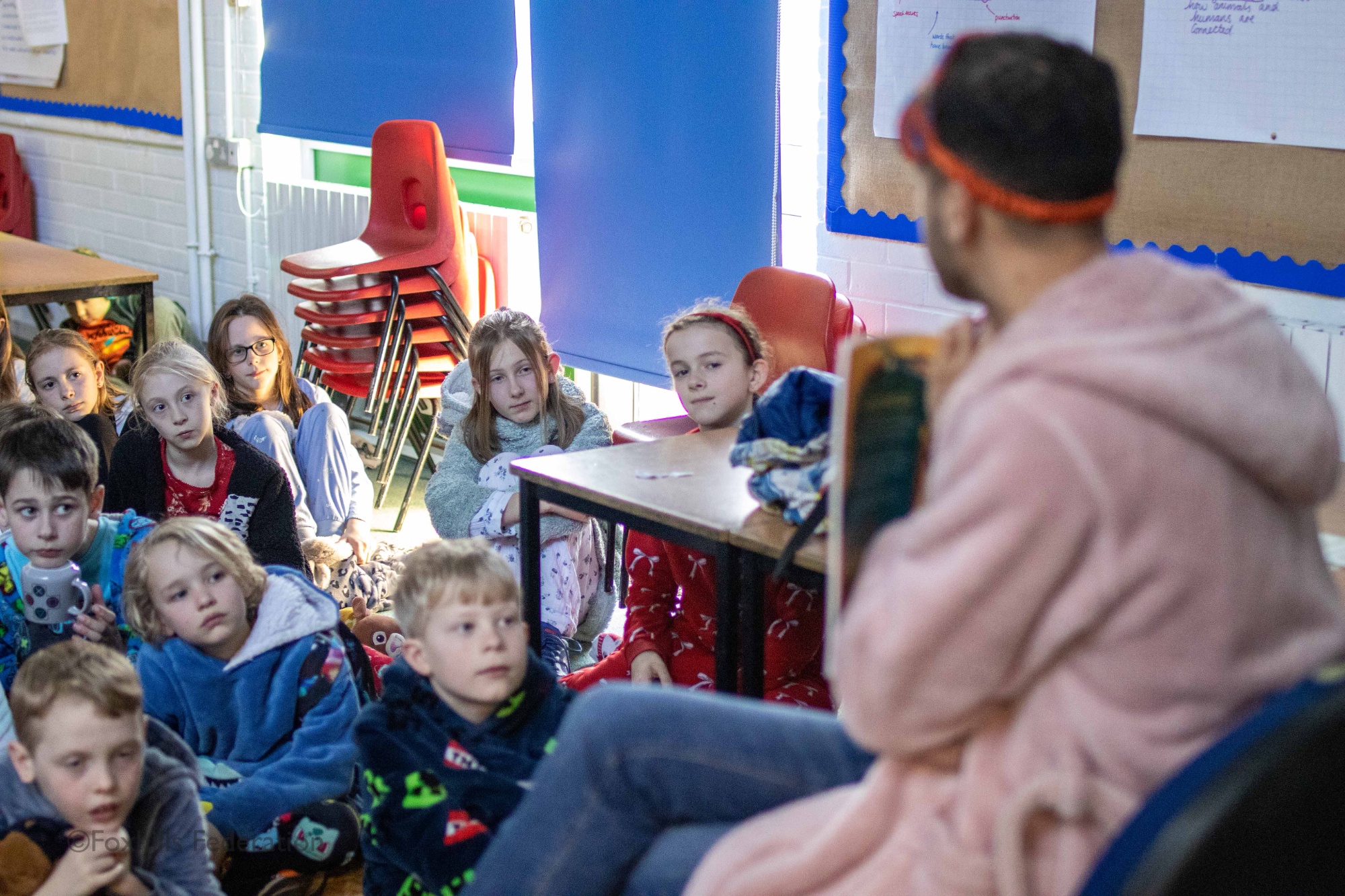 Children listen to a story being read to them