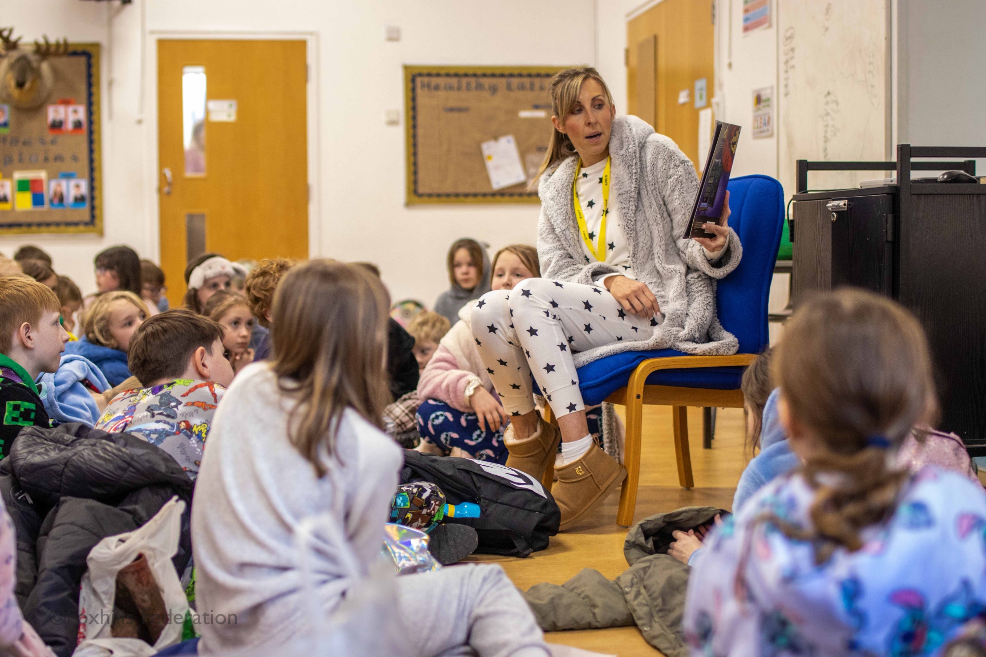 Mrs Howe reads a book to the whole school