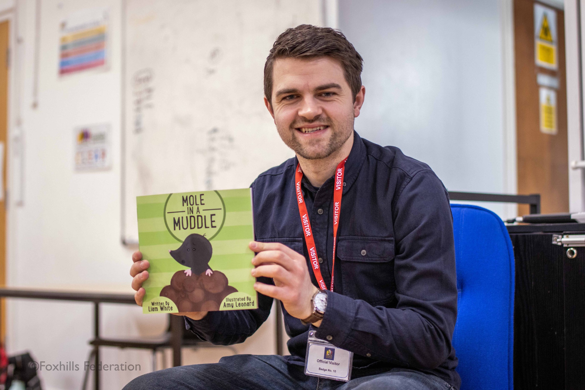 Local author Liam White holds up his new book: “Mole in a Muddle”