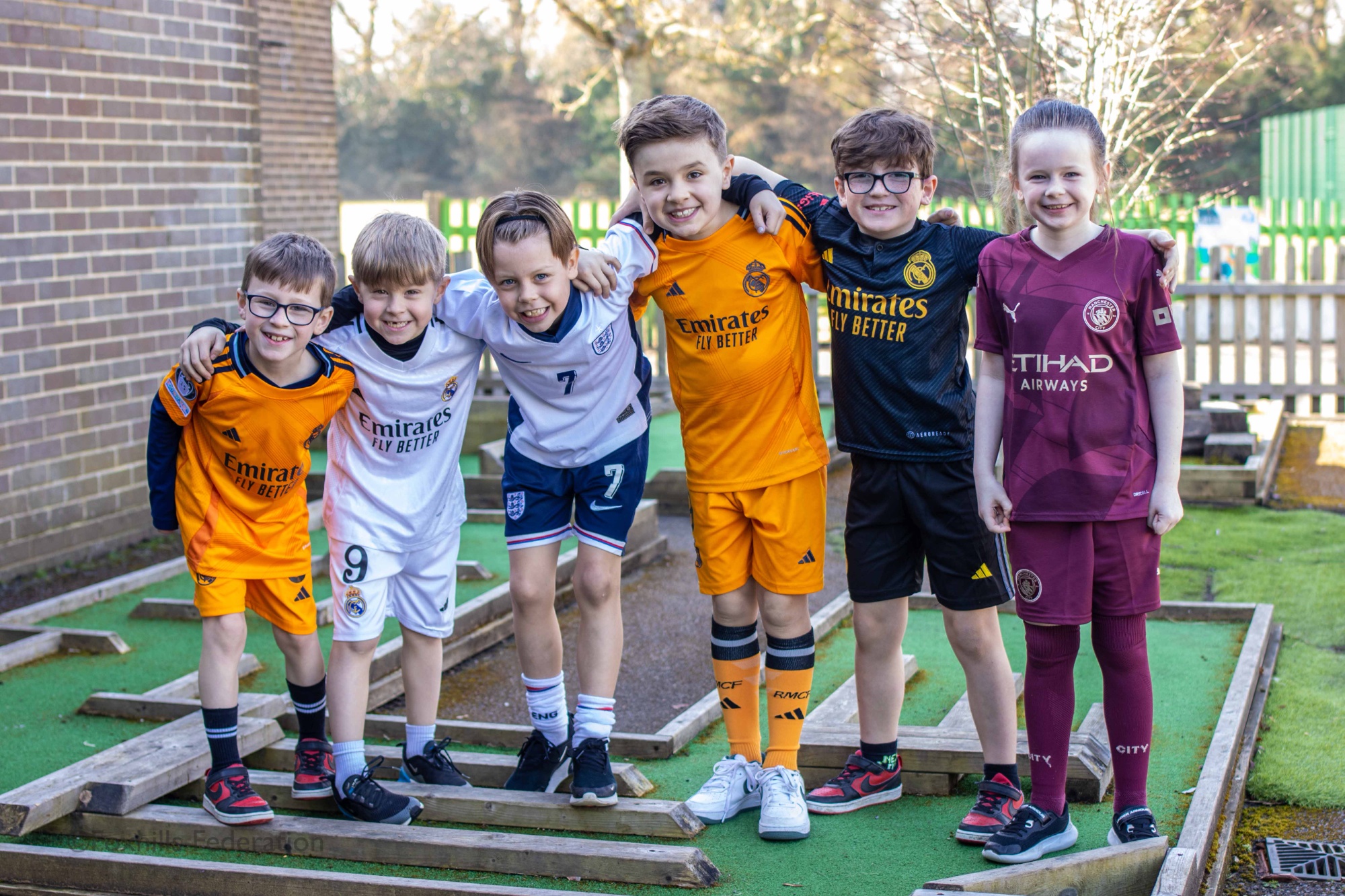 Children pose as footballers